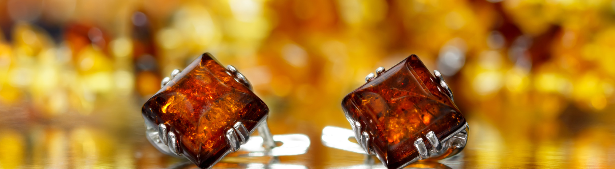 Closeup of Silver Earrings With Baltic Amber